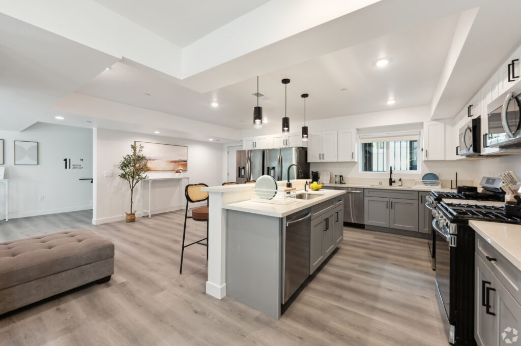 Side view of a fully furnished kitchen with modern amenities at Nest Housing near USC